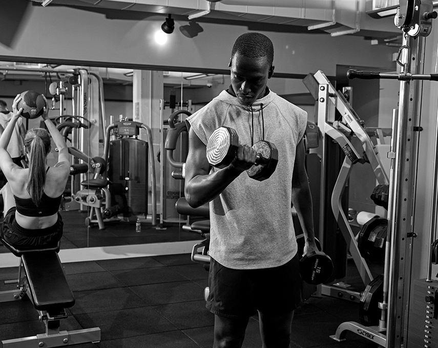 man and woman working out in fitness center