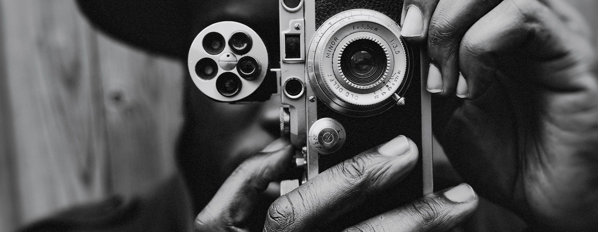 man taking photo with film camera