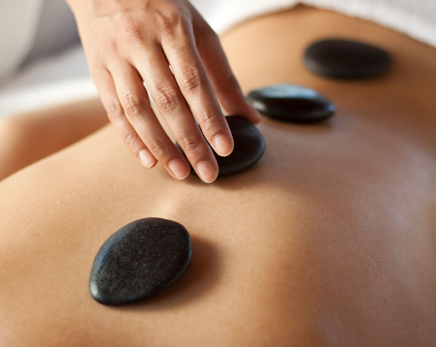 person getting hot stones on the back