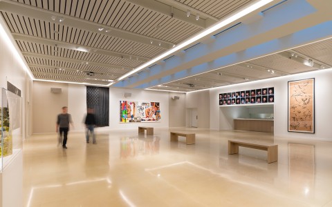 large room with multiple large art pieces on the wall