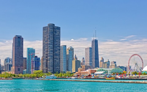 chicago skyline next to boardwalk with ferris wheel