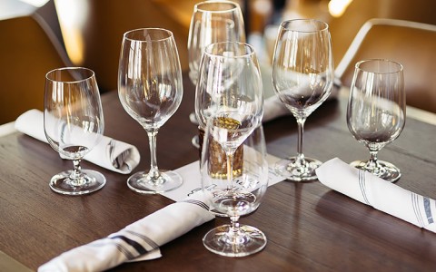 wine glasses on dark wood table