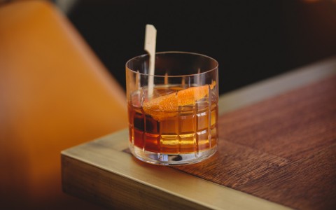 Glass of bourbon and an orange peel