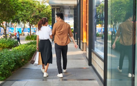 man and woman walking on a sidewalk
