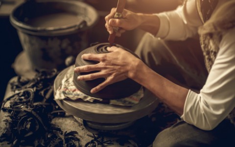 artist sculpting pottery