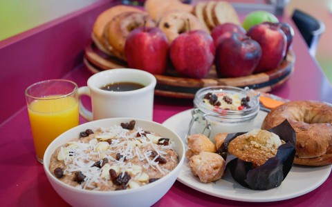 breakfast with muffins, orange juice, fruits, and oatmeal