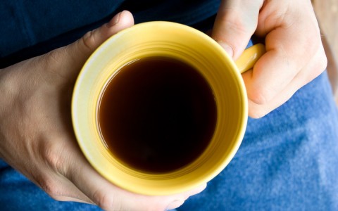 person holding a mug full of coffee
