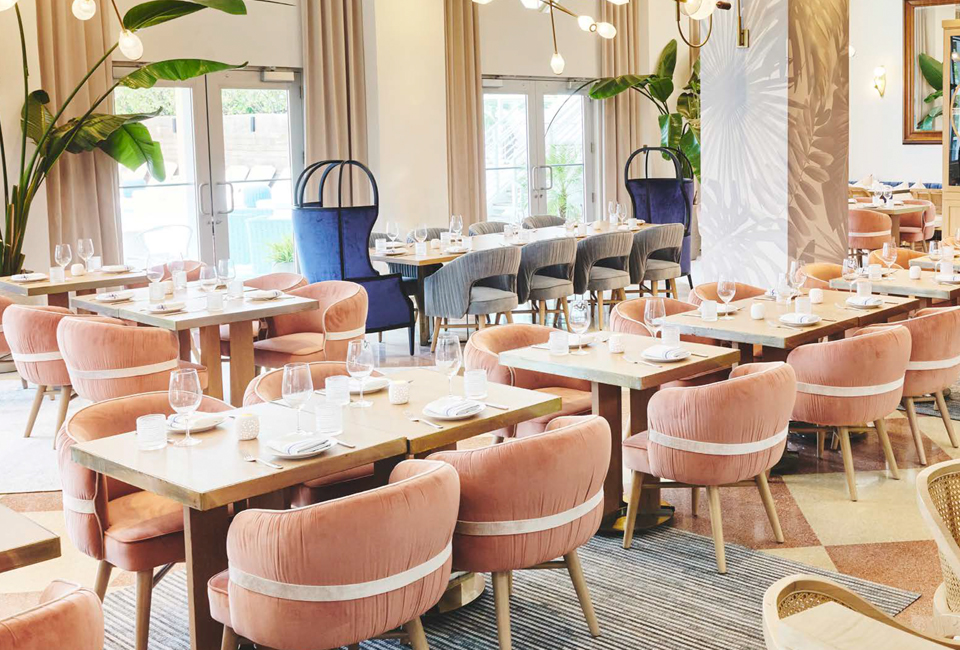restaurant dining tablets with light pink cushioned chairs