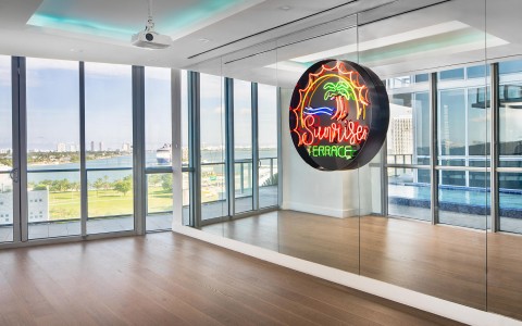 view of a room with mirrors and the sunrise terrace logo 