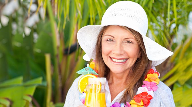 woman with fruity cocktail and floppy hat