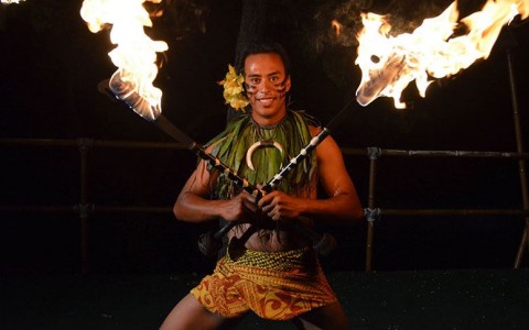 man with two fire dance sticks