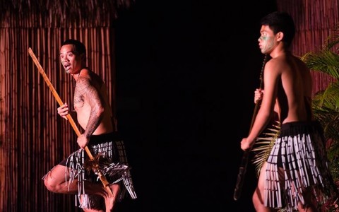 two people on stage with tribal sticks