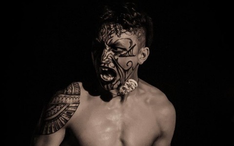man with tribal tattoos on his face