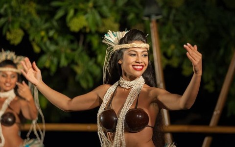 woman during a hula dance with coconut bras