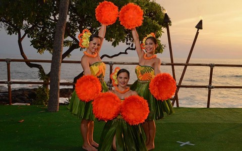 luau dancing outside at sunset