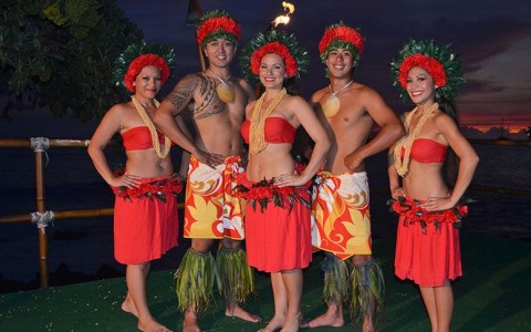 group of performers posing with orange floral costumes