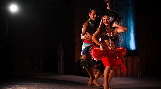 male and female luau dancers on stage