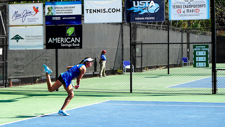 a person in a blue shirt playing tennis