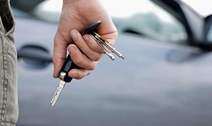 close up of a person holding car keys