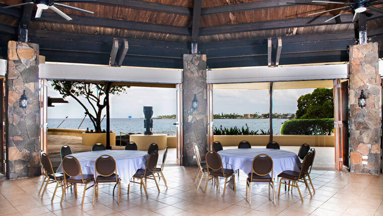 Event space with wooden ceilings overlooking an oceanfront view 