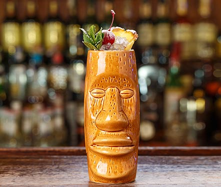 tiki cup in front of a bar