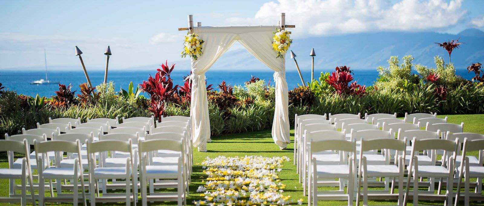 Wedding aisle arrangement with ocean at the back 