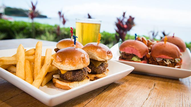 a table with sliders and fries