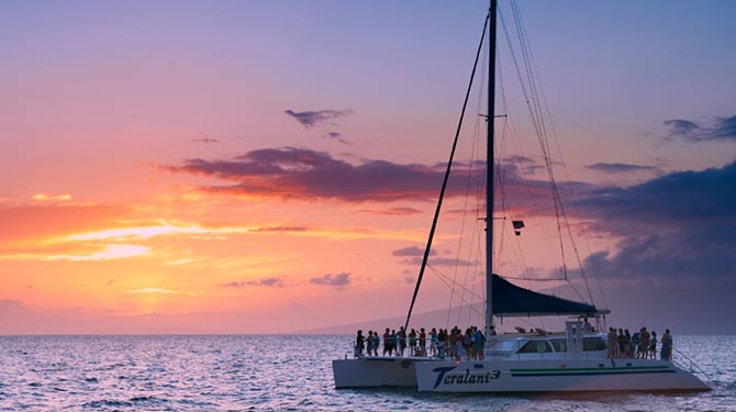 Boat sailing at sunset