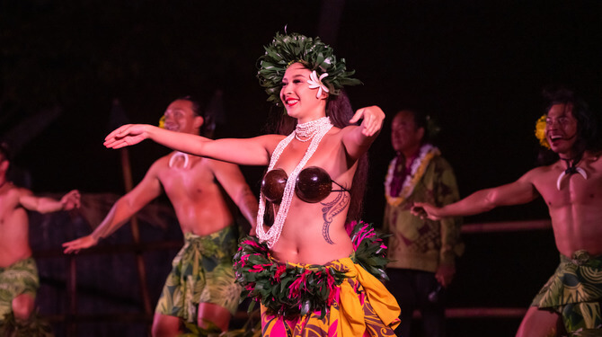 women dancing in luau performance with coconut bra and skirt 