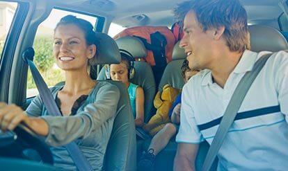 Family in car going on vacation