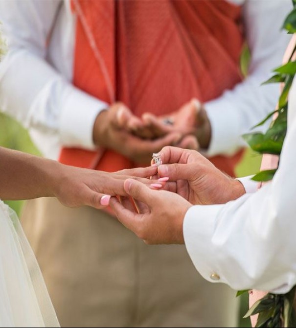 a couple exchanging rings during their wedding