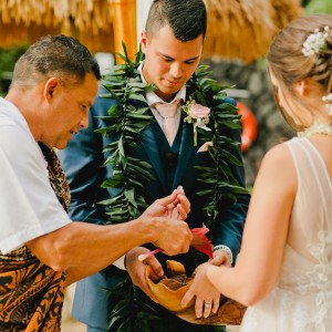 couple at the altar receiving a traditional hawaiian ritual