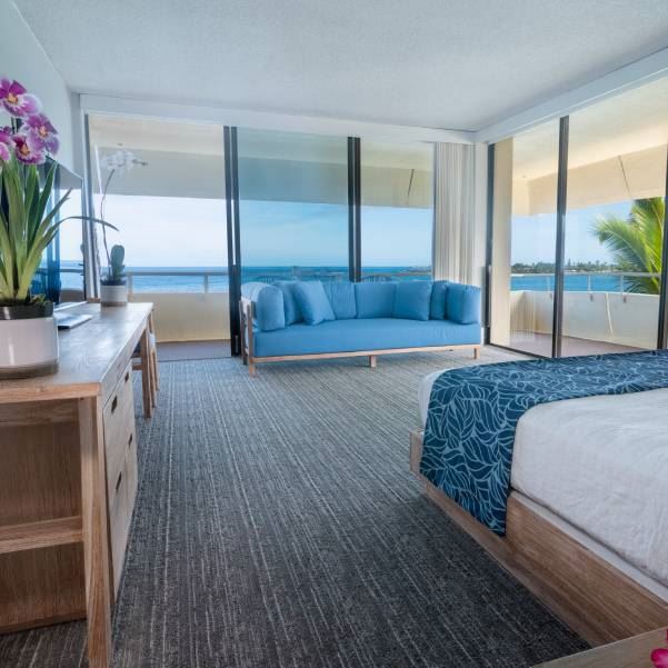 large corner king ocean view hotel suite with multiple windows