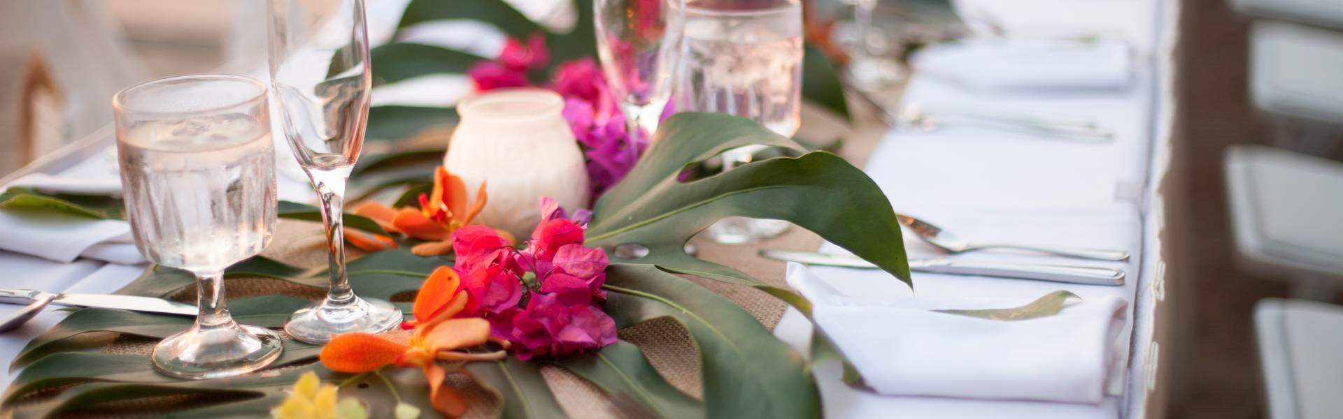 table settings with bright pink flower arrangements