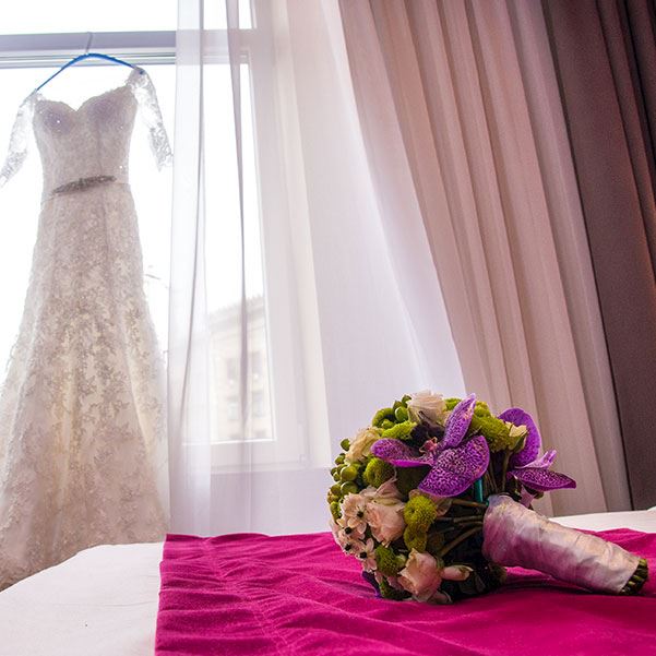 wedding dress hanging on a window 