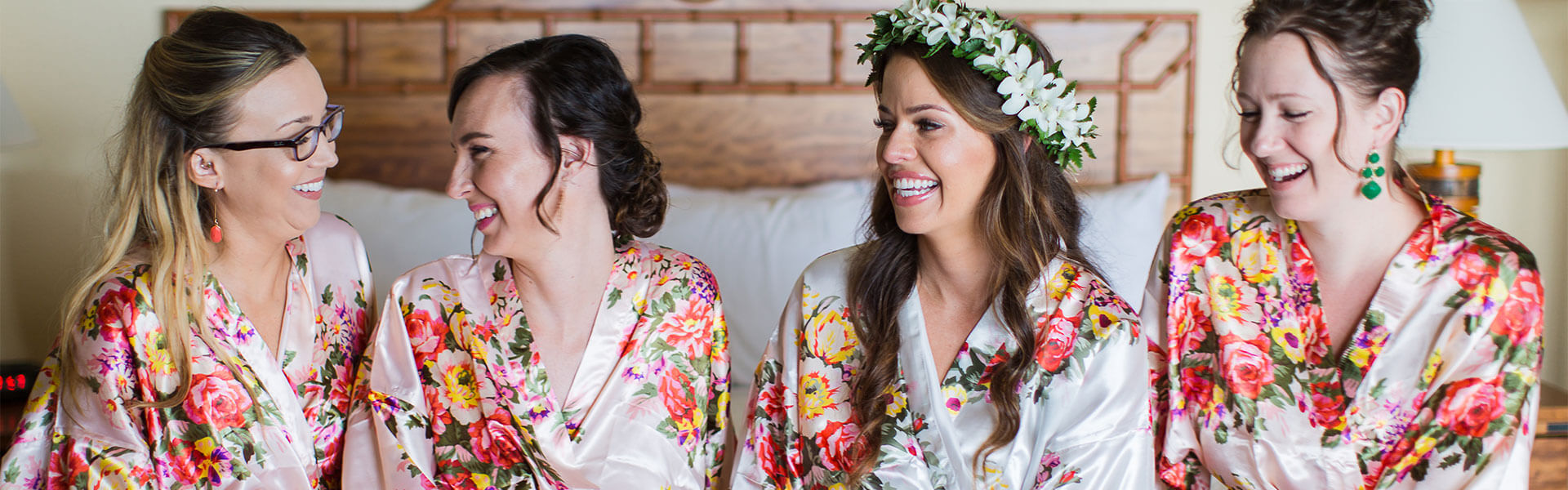 bride and her bridesmaids in a room with floral robes