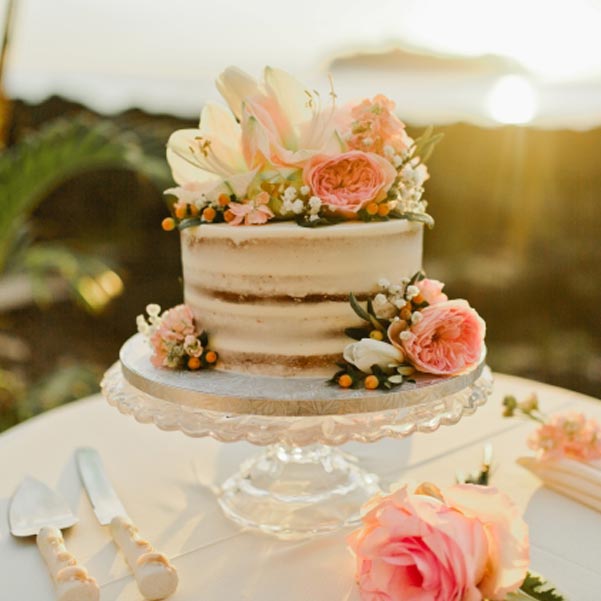 rustic wedding cake with multiple layers and minimal frosting