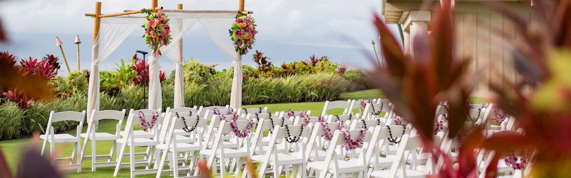 chairs set up on the beach for a wedding ceremony