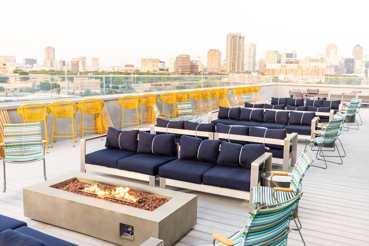 rooftop view with couches and a skyline in the background