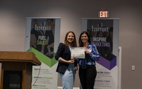 two women holding up a certificate