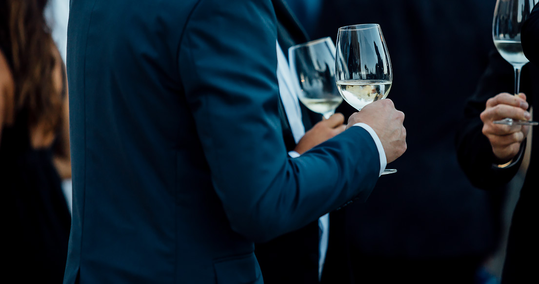 people holding glasses of wine