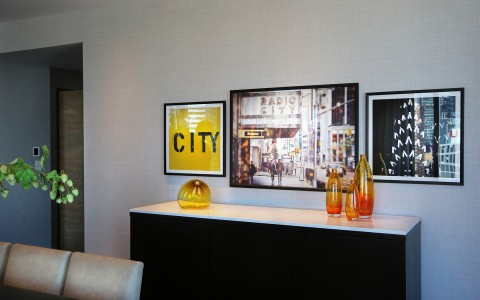 inside the manhattan suite, 3 picture frames with pictures of the city and 4 vases on the vanity