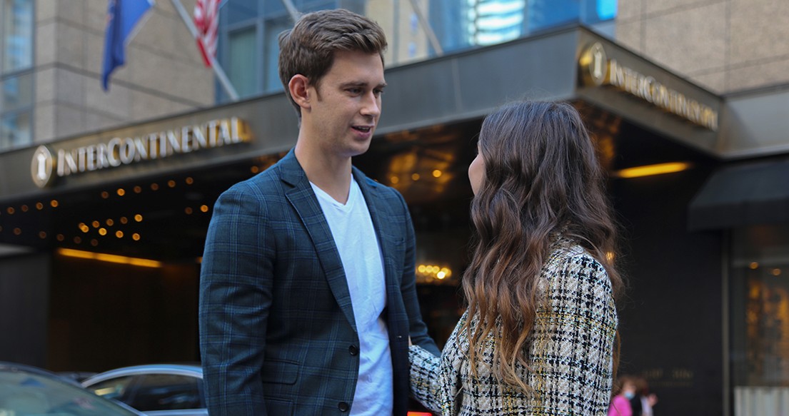 man looking at women in front of hotel