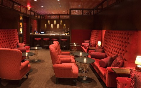 nice red dining area with couches and chairs for drinks