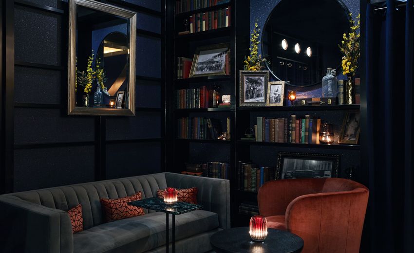 colorful lobby seating area with couch and bookshelf