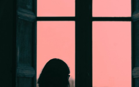 person looking out of window