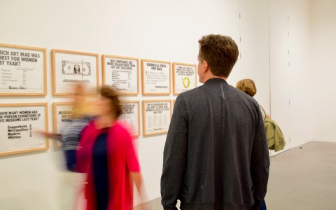 person walking through an art gallery