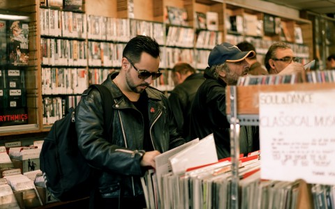 person looking through vinyls at the record store