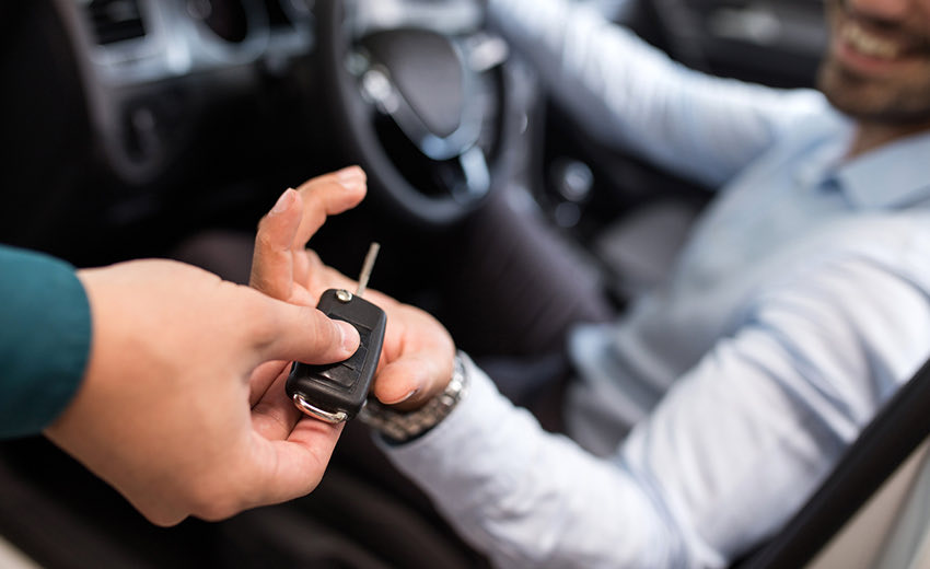 giving a person their keys at valet station