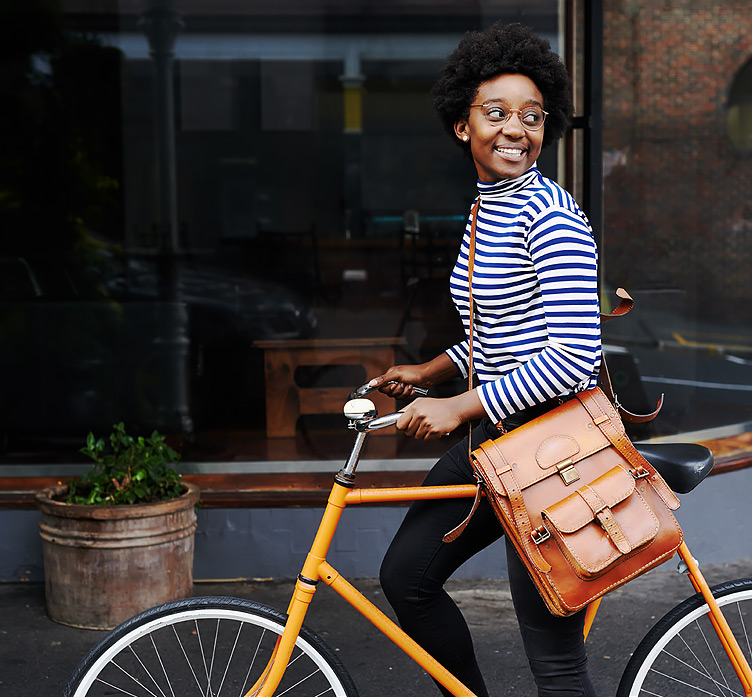 woman on an orange bike in the city